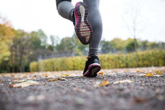 Women Athlete Running on Gravel Road