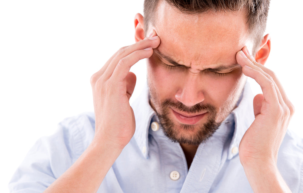 Man experiencing pain from frequent headaches