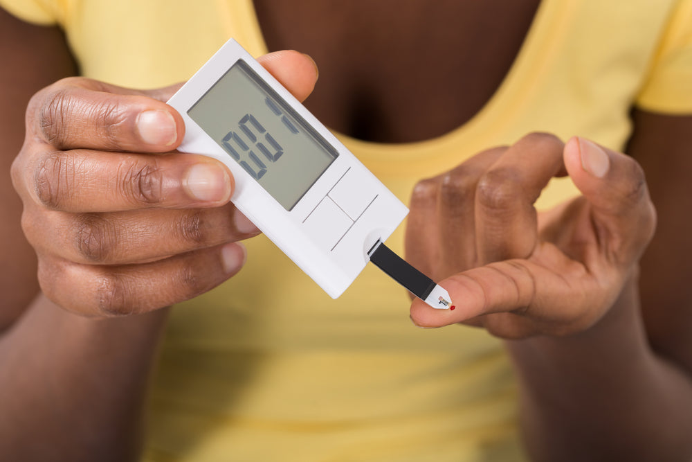 Woman with hypoglycemia testing her blood sugar