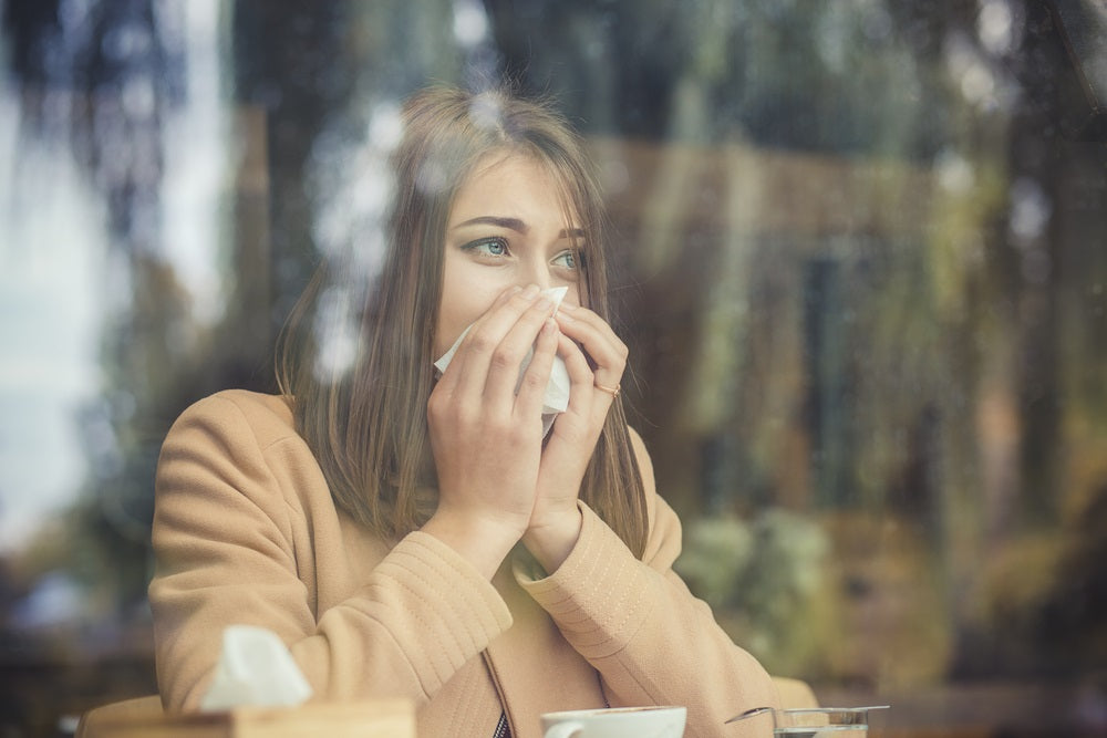 Women Struggling with Allergies Looking Through a Window
