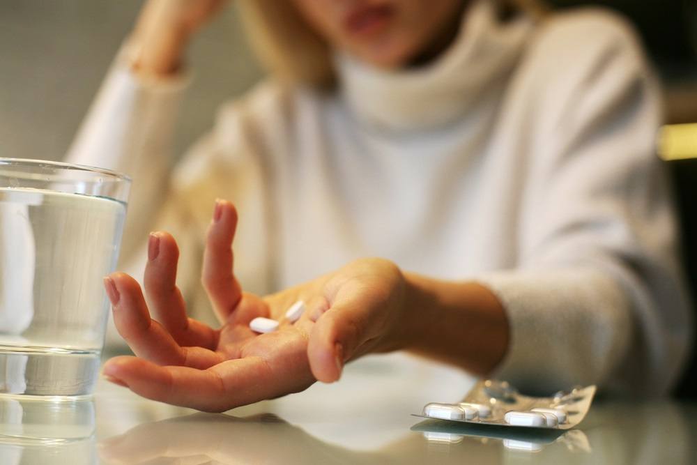 Women Preparing to Take Two Painkillers
