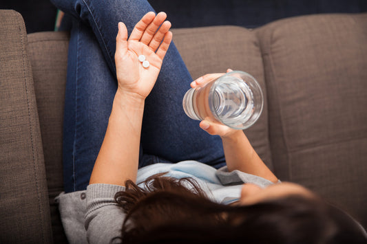 Woman Taking Medicine with Water