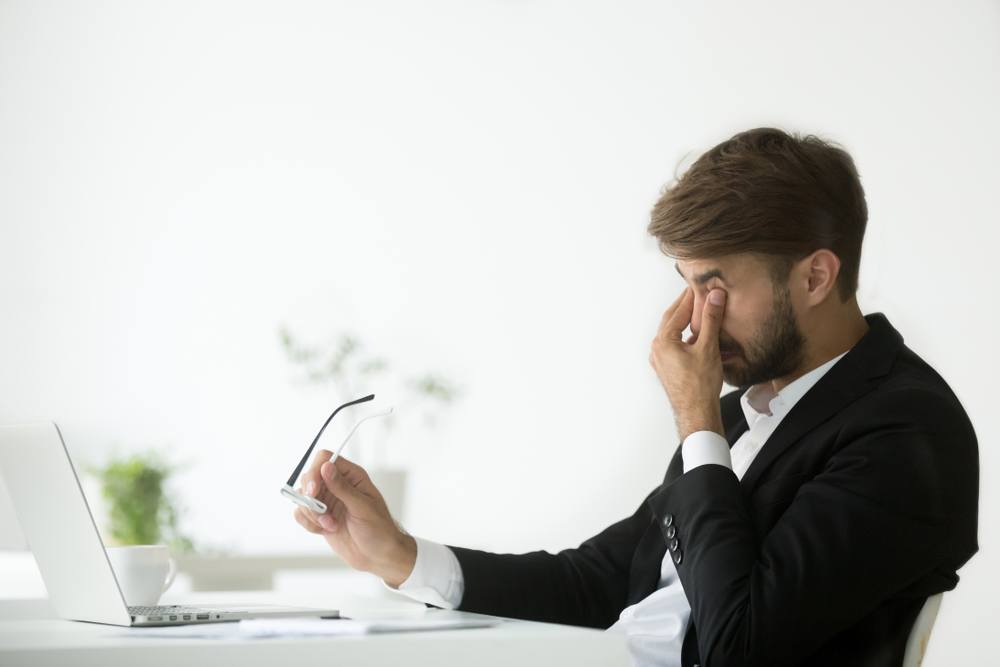 man with headache from staring at computer screen