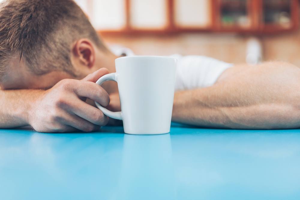 man with headache from caffeine withdrawal
